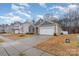 Attractive single-Gathering home features stone accents, a two-car garage, and a landscaped yard at 654 Saddlebred Ln, Locust, NC 28097