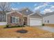 Beautiful single-Gathering home with stone accents, well-kept lawn, and attached garage at 654 Saddlebred Ln, Locust, NC 28097
