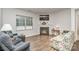Inviting living room with a cozy fireplace, large window, and hardwood flooring at 654 Saddlebred Ln, Locust, NC 28097