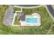 Aerial view of community pool with seating, manicured landscaping, and parking at 654 Saddlebred Ln, Locust, NC 28097