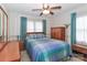 Bedroom with wood flooring, ceiling fan, and ample closet space at 105 Kiser Ln, Statesville, NC 28677