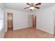 Bedroom with wood floors, access to bathroom, and ceiling fan at 105 Kiser Ln, Statesville, NC 28677