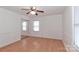 Bright bedroom with wood floors, mirrored closet doors, and ceiling fan at 105 Kiser Ln, Statesville, NC 28677