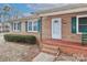 Brick front entrance with green shutters and rocking chair at 105 Kiser Ln, Statesville, NC 28677