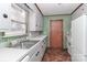 Updated kitchen with white cabinets, stainless steel sink, and new flooring at 105 Kiser Ln, Statesville, NC 28677