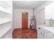 Laundry room with water heater, built-in shelving, and extra storage at 105 Kiser Ln, Statesville, NC 28677