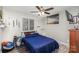 Cozy bedroom with a double bed, window blinds, and wall art at 11800 Five Cedars Rd, Charlotte, NC 28226