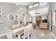 Bright dining room with a white table, chandelier, and view into the living room at 11800 Five Cedars Rd, Charlotte, NC 28226