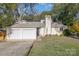 Ranch home with a three-car garage and landscaped lawn at 11800 Five Cedars Rd, Charlotte, NC 28226