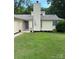 Inviting one-story home with a manicured lawn, an entryway adorned with potted plants, and a classic chimney at 11800 Five Cedars Rd, Charlotte, NC 28226