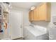 Laundry room with washer, dryer, and ample storage at 11800 Five Cedars Rd, Charlotte, NC 28226