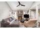 Living room with stone fireplace, sectional sofa, and large TV at 11800 Five Cedars Rd, Charlotte, NC 28226