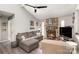 Living room with sectional sofa, stone fireplace, and ceiling fan at 11800 Five Cedars Rd, Charlotte, NC 28226
