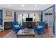 Cozy living room with plush armchairs, a fireplace, and ample natural light from the large windows at 2106 Yellowstone Dr, Fort Mill, SC 29707