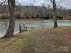 Concrete boat ramp leading to the lake, surrounded by mature trees, offering easy access for boating at 6249 Hayden Dr, Hickory, NC 28601