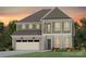 Charming two-story home with stone accents, a two-car garage, and manicured landscaping at 1068 Kinship Dr # 111, Lancaster, SC 29720