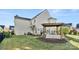 Grassy backyard featuring a pergola-covered patio, seating, and a grill area perfect for entertaining outdoors at 13929 Tilesford Ln, Huntersville, NC 28078
