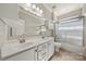 Bathroom featuring double sinks, shower/tub combo, and ample lighting, perfect for a growing Gathering at 13929 Tilesford Ln, Huntersville, NC 28078