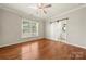 Bright bedroom features hardwood floors, ceiling fan, and ensuite bathroom at 13929 Tilesford Ln, Huntersville, NC 28078