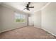 Cozy bedroom with large windows and neutral tones, creating a relaxing and inviting space at 13929 Tilesford Ln, Huntersville, NC 28078