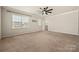 Bright bedroom with large window, neutral paint, and plush carpeting at 13929 Tilesford Ln, Huntersville, NC 28078