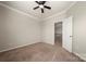 Bedroom with neutral paint, carpet, a ceiling fan and adjacent staircase at 13929 Tilesford Ln, Huntersville, NC 28078