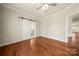 Spacious bedroom features hardwood floors, ceiling fan, and ensuite bathroom at 13929 Tilesford Ln, Huntersville, NC 28078