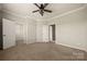 Large carpeted bedroom with doorways to closet and hall offering space and convenience at 13929 Tilesford Ln, Huntersville, NC 28078