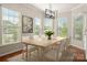 Bright dining room with a wooden table set under an elegant chandelier at 13929 Tilesford Ln, Huntersville, NC 28078