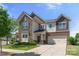 Charming two-story home featuring a combination of stone and siding, a well-manicured lawn, and a welcoming entrance at 13929 Tilesford Ln, Huntersville, NC 28078