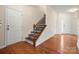 Elegant foyer featuring hardwood floors, wainscoting, and a staircase with decorative risers at 13929 Tilesford Ln, Huntersville, NC 28078