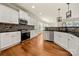 Spacious kitchen with white cabinets, stainless steel appliances, and hardwood floors at 13929 Tilesford Ln, Huntersville, NC 28078