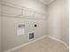 Laundry room with tile flooring, overhead shelving and utility connections at 13929 Tilesford Ln, Huntersville, NC 28078