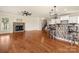 Open-concept living area with fireplace, staircase, and kitchen in the background at 13929 Tilesford Ln, Huntersville, NC 28078