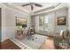 Bright home office with a modern desk, chair, and lots of natural light at 13929 Tilesford Ln, Huntersville, NC 28078
