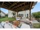 Cozy backyard patio with a pergola, comfortable seating, grill and lush lawn, ideal for outdoor entertaining at 13929 Tilesford Ln, Huntersville, NC 28078