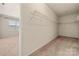 Spacious walk-in closet with ample shelving and storage, providing organization and convenience at 13929 Tilesford Ln, Huntersville, NC 28078