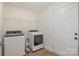 Bright laundry room featuring modern washer and dryer, white shelving and neutral paint at 2215 Charlotte Hwy, York, SC 29745