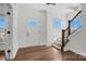 Bright foyer with hardwood floors, staircase, and natural light streaming through windows at 2237 Millennium Dr # 012, Lancaster, SC 29720