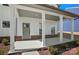 Inviting front porch with white columns, brick accents, and a stylish entrance door at 2237 Millennium Dr # 012, Lancaster, SC 29720