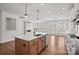 Open-concept kitchen with a center island flowing into the living area with fireplace at 2237 Millennium Dr # 012, Lancaster, SC 29720
