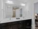 Bathroom with a double sink vanity, a large mirror, and view of tiled shower at 208 Waterlynn Ridge Rd # B, Mooresville, NC 28117