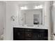 Bathroom with double vanity sinks and an oversized mirror with decorative lighting at 208 Waterlynn Ridge Rd # B, Mooresville, NC 28117