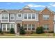 Charming multi-story townhome featuring a brick facade, large windows, and well-maintained landscaping at 208 Waterlynn Ridge Rd # B, Mooresville, NC 28117