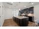 Modern kitchen with dark cabinetry, granite countertops, and stainless steel appliances, perfect for cooking and entertaining at 208 Waterlynn Ridge Rd # B, Mooresville, NC 28117