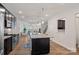 Bright, open-concept kitchen with a large island, stainless steel appliances, and views of the living room at 208 Waterlynn Ridge Rd # B, Mooresville, NC 28117