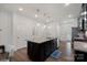 Modern kitchen features a central island with granite countertops and stainless steel appliances at 208 Waterlynn Ridge Rd # B, Mooresville, NC 28117