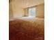Spacious bedroom with a sliding glass door leading to a private balcony at 7324 Pebblestone Dr # F, Charlotte, NC 28212
