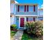 Charming townhome with colorful shutters and a well-maintained front garden with flowering bushes at 7324 Pebblestone Dr # F, Charlotte, NC 28212