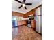 Well-lit kitchen with stainless steel appliances, wood cabinets, and a ceiling fan at 7324 Pebblestone Dr # F, Charlotte, NC 28212